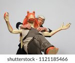 Small photo of JUNE 22 2018: Political Satire concept of US President Donald Trump holding back Star Wars slapstick ambassador Jar Jar Binks