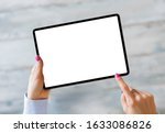 Woman holding tablet with empty white screen