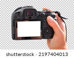 Modern digital mirrorless camera mockup. Photographer holding camera in hand, transparent background pattern.