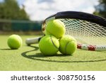 Tennis balls and racket on the grass court