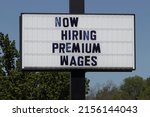 Small photo of Now Hiring Premium Wages sign. Amid a nationwide shortage of workers, companies, businesses and restaurants are increasing wages to attract applicants.