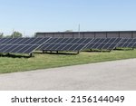Small photo of Solar panels and solar electricity farm. Many companies are converting unused land into solar farms to reduce their environmental impact on the planet.