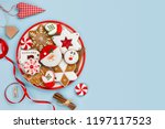 Painted gingerbread cookies and Christmas decoration isolated on blue background