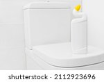 Toilet cleaner bottle mockup for design on white lavatory pan