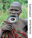 Small photo of OMO VALLEY, ETHIOPIA - FEB 5: unidentified Surma woman posing in the village,the ethnic groups in the The Omo valley Could disappear Because of Gibe III hydroelectric dam on Feb 5, 2013 in Omo Valley, Ethiopia.