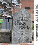Small photo of Greenville, SC - May 6, 2023: Falls Park on the Reedy stone sign at the entrance to the park in Greenville, SC