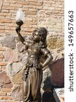 Small photo of retro historic nympho sculpture near museum entrance holding lighting lamp in hand.