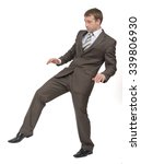Small photo of Businessman walking gingerly on isolated white background, rear view