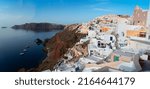 Small photo of traditional greek village Oia of Santorini, street against deep Aegan sea and caldera, Greece, web banner format