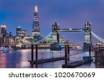City skyline at sunset with London Tower Bridge and the Shard on Thames river in England