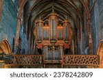 Small photo of Strasbourg, France - May 31, 2023: A gothic archway of the rood screen and an ornate organ in the Saint Pierre le Jeune Protestant church