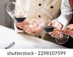 Small photo of Red wine tasting. Participants compare the colors of different red wines in a wine tasting event, learning to identify the wine's age, grape varietal, and other key details based on hue.