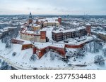 Small photo of Krakow skyline with historic royal Wawel Castle and Cathedral in winter. White snow, walking people and promenade