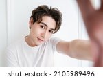 Small photo of Portrait of young handsome asian man use smartphone selfie say hi over white background. Happy asian guy online influencer blogger. Education technology connected people man lifestyle concept