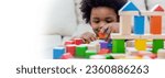 Small photo of Little boy hands of little children play blocks in classroom. Learning by playing education group study concept. International pupils do activities brain training in primary school background banner
