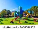  Cozy and safe children's playground. Variety of colorful rides. Outdoor sunny lawn for children. Bright warm sunny morning. The concept of physical and mental development of children