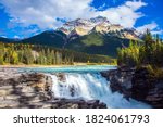 Mountains, rivers and waterfalls make up magnificent landscapes. Jasper Park. Rocky Mountains of Canada. Athabasca Falls. Travel, ecological and photo tourism concept