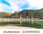 The magnificent ruins of Katz Castle. Medieval romantic castles and ruins. Warm autumn in Germany. Beautiful wooded slopes of the coastal hills of the great river Rhine.  
