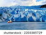 Gray Glacier is part of the South Patagonian Ice Field. The Gray Glacier is the third largest in the world. Boat with tourists floats among icebergs. 