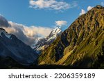 Evening twilight in the valleys. The highest mountain in New Zealand is Aoraki, or Mount Cook. The top of the mountain is covered with eternal snows. The concept of active, walking and photo tourism
