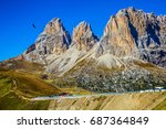 Picturesque road through the pass. Three dizzy dolomite peaks on the Sella Pass, Dolomites. The concept of extreme and ecological tourism