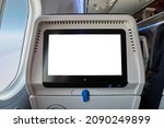 Using the seatback screen on a plane trip, watching movies, displaying flight data. Blank white touchscreen