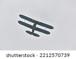Old historic biplane aircraft in the sky flying