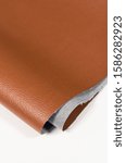Small photo of leather material imitation leather close-up texture edge corner macro front side wrong side color brown