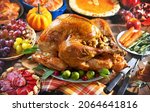 Small photo of Thanksgiving turkey dinner. Roasted turkey on holiday table with pumpkins, pie, fruits, flowers and wine