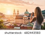 Tourist taking a photo with mobile of beautiful sunset in Salzburg Austria