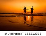 Silhouettes Of Couple Running...