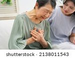 Small photo of Asian senior woman having a palpitation of the heart