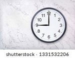 Small photo of Wall clock show nine o'clock on white marble texture. Office clock show 9pm or 9am on marble background