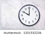 Small photo of Wall clock show ten o'clock on white marble texture. Office clock show 10pm or 10am on marble background