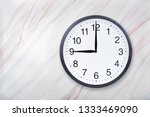 Small photo of Wall clock show nine o'clock on marble texture. Office clock show 9pm or 9am on marble texture with natural pattern