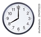 Small photo of Round office clock showing eight o'clock isolated on white background