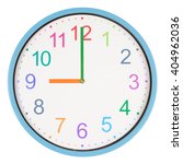 Small photo of Colorful clock showing nine o'clock isolated on white background