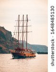 Small photo of Fira, Santorini, Greece - 10.10.2019: This is a view of two gullet sailing vessels moored at the old port at Fira. Summer travel scenery and adventure, outdoor view. Vacation landscape and sea view