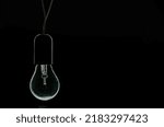 Small photo of turned off incandescent light bulb on a black background