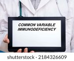 Small photo of Common Variable Immunodeficiency. Doctor with rare or orphan disease text on tablet screen Common Variable Immunodeficiency