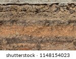 Small photo of Close-up background image, cut section, gravel layer and mud under the concrete road, which was excavated to embed the pipe.