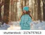 Little girl in a winter forest...