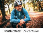 Happy male cyclist in forest.