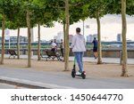 People use and ride E-scooters, trendy urban transportation with Eco friendly mobility concept by sharing Electric Scooter, at promenade riverside of Rhine River in Düsseldorf, Germany.