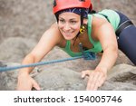 Happy Girl Climbing Rock Face...