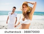 Smiling couple holding hands on the beach
