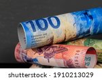 Swiss money. Banknotes of the Swiss franc, several of which have been rolled up and stacked on top of each other. CHF currency.