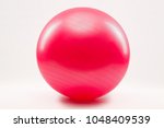 Red Fitness ball and pilate against a white background