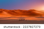 Small photo of Camel caravan in the desert at sunrise - Sahara, Morrocco