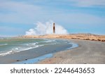 Small photo of Rocky coastline on Diaz Point with power sea wave - Amazing red and white lighthouse - Diaz Point, Luderitz, Namibia